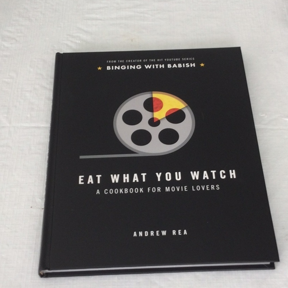 Eat What You Watch: A Cookbook for Movie Lovers by Andrew Rea - Black Cover